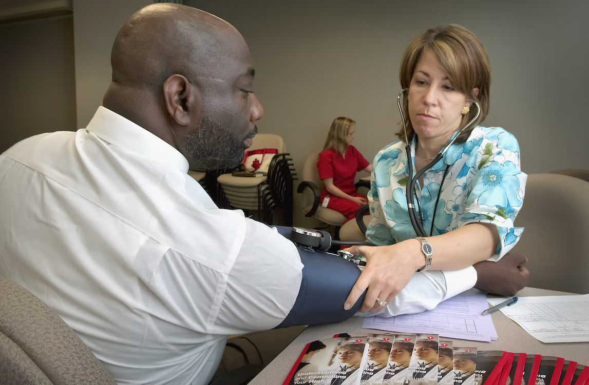 Rest your arm with the cuff on a table at chest height